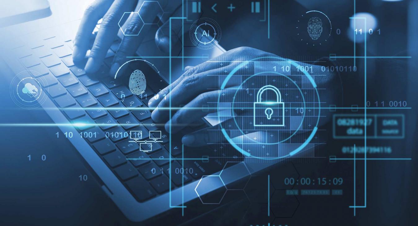 Composite of person typing on a laptop and cybersecurity icons