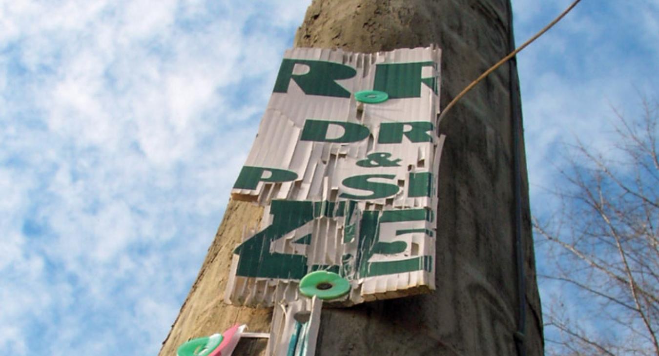 Sign nailed on utility pole