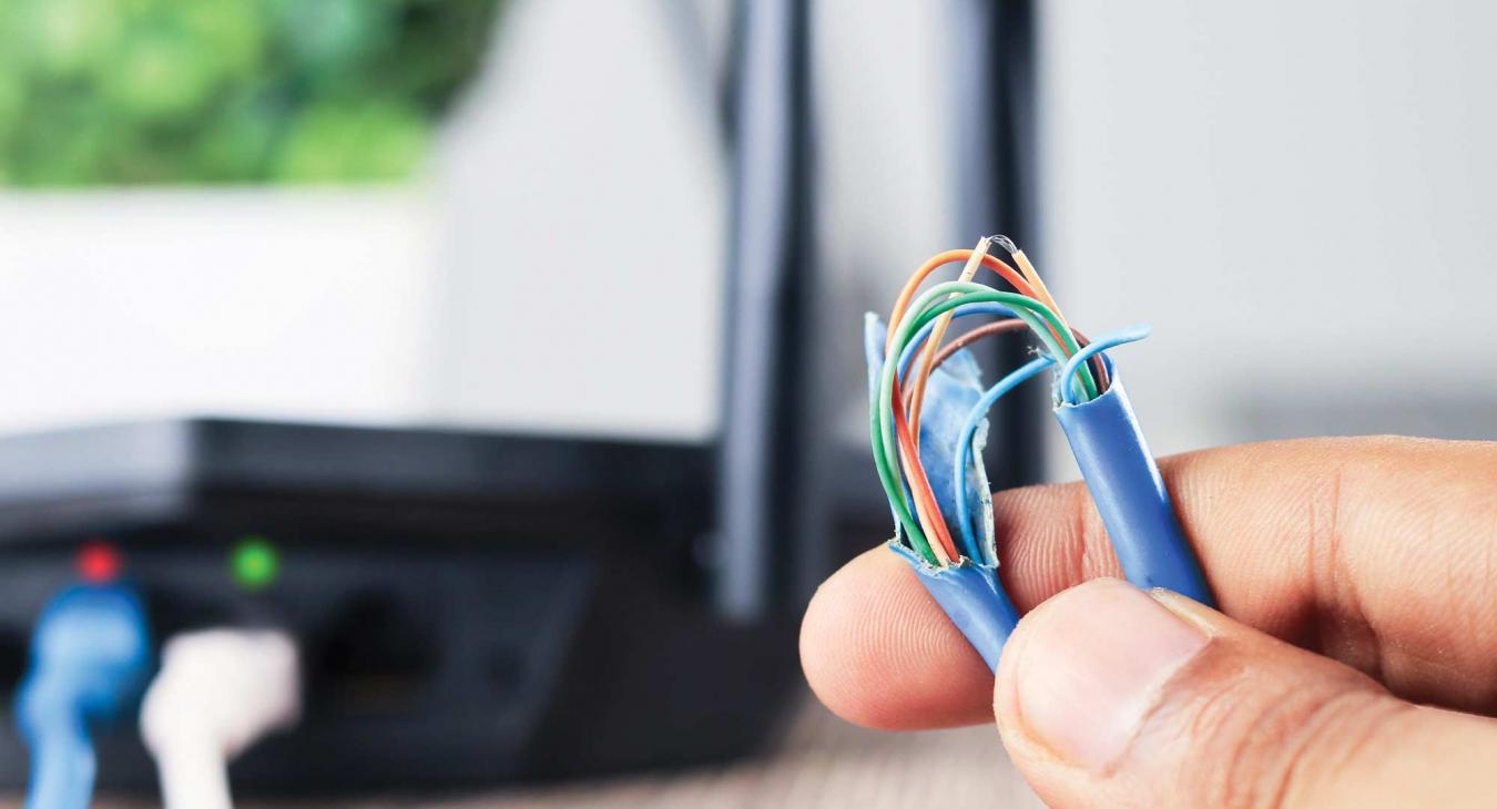 Hand holding broken electric cord