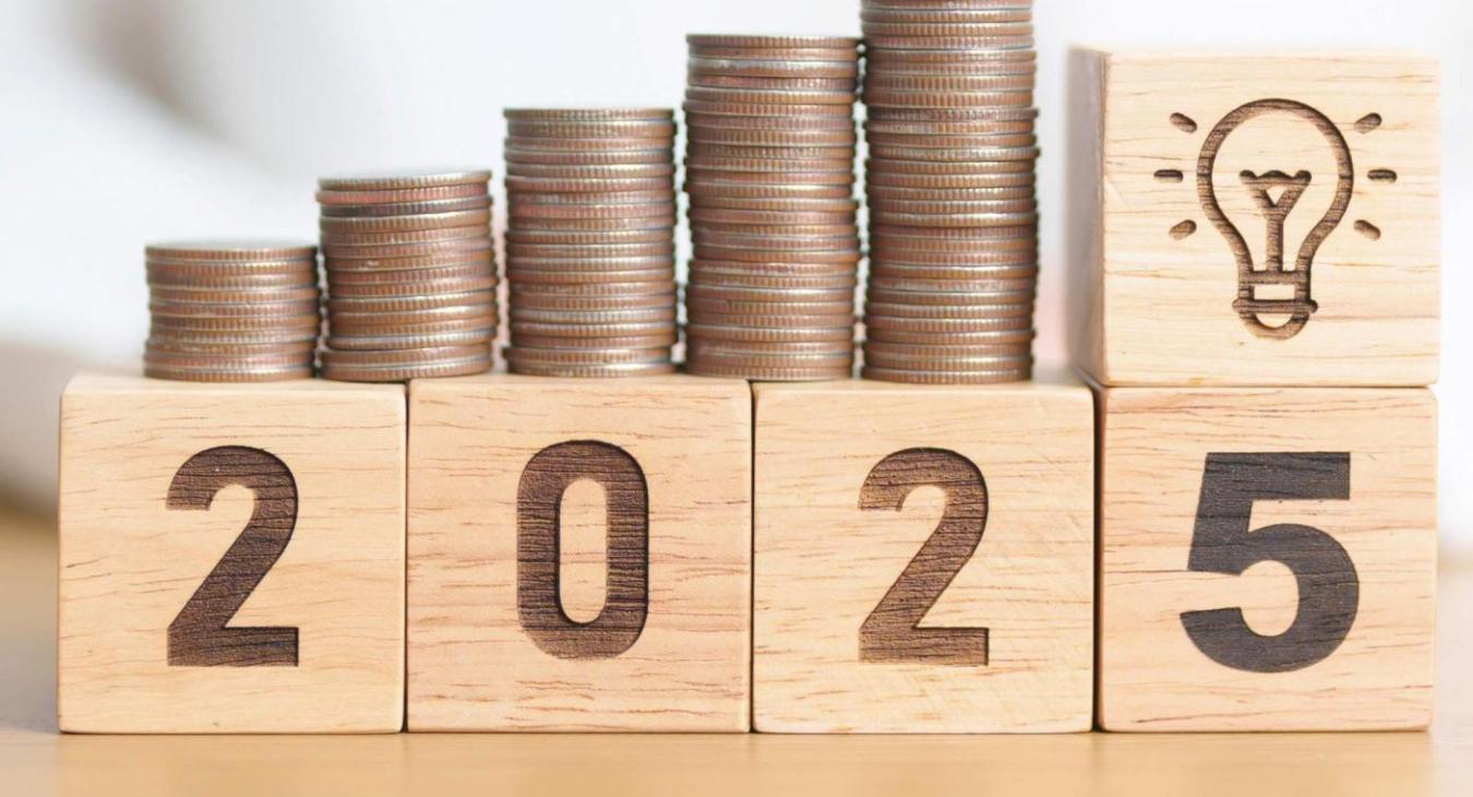 stacks of coins on top of wood blocks that display the year 2025