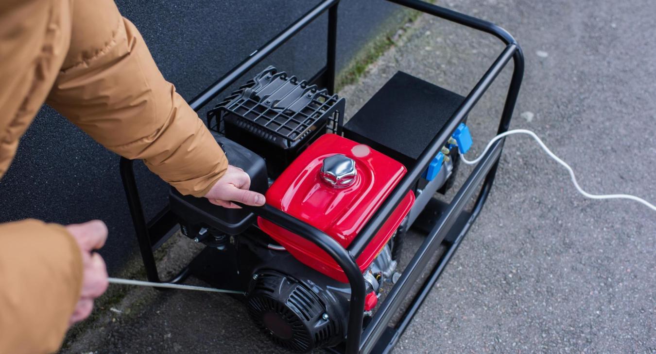Person starting a portable generator